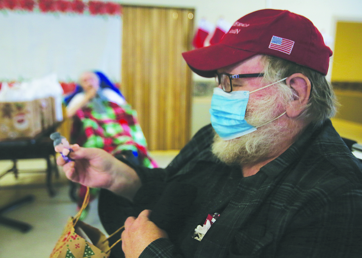 Rick Lamson smiles at a toy he pulled from a goodie bag Thursday during a visit from Silver Angels for the Elderly at Lacrosse Health and Rehabilitation Center.