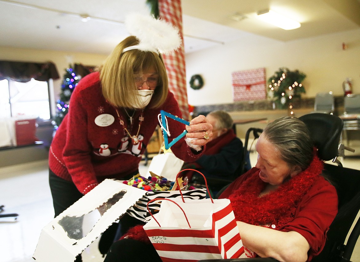 Silver Angels for the Elderly founder Diane Zell shares Christmas trinkets with Lacrosse Health and Rehabilitation Center resident Vicky Way on Thursday.