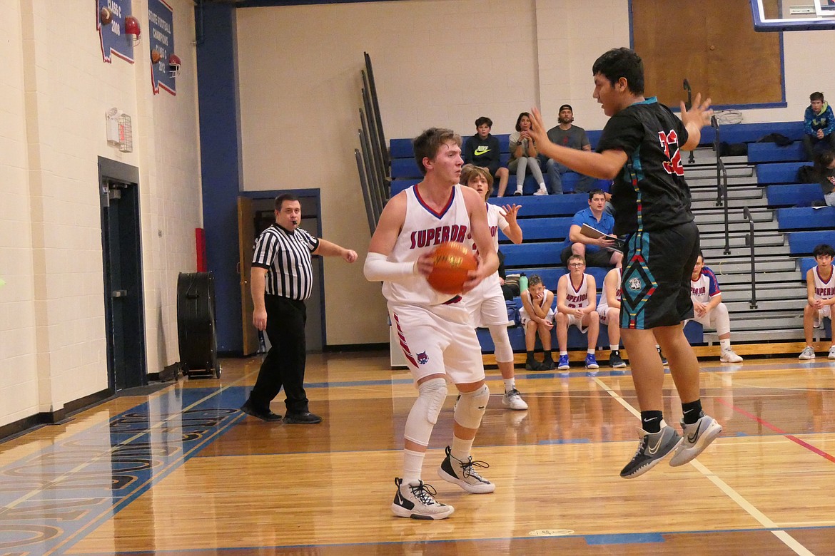 Anthony Mueller gets Two Eagle River forward Ryiley AfterBuffalo off his feet as he looks for an open teammate Tuesday against the Eagles in Supeior. (Chuck Bandel/Valley Press)