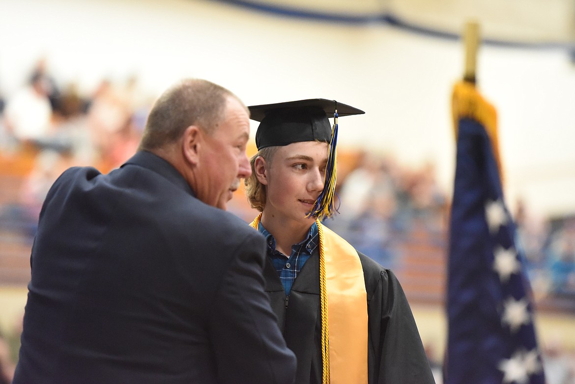 Jim Germany of Libby Middle High School speaks with a matriculating senior at this year's graduation. (File photo)