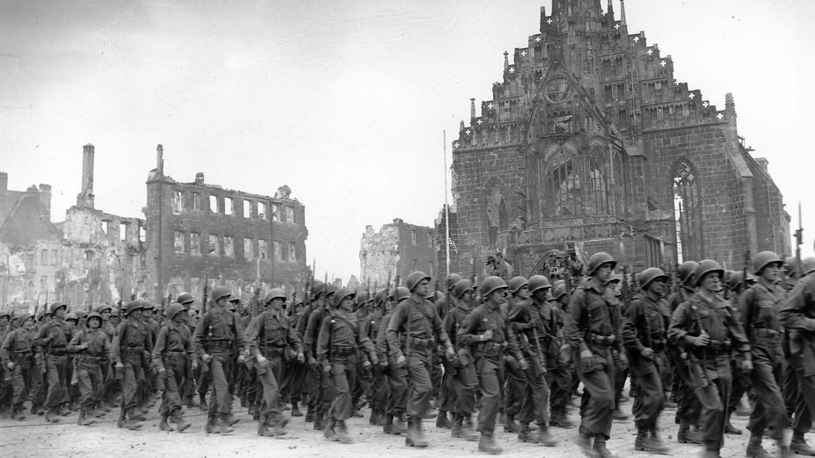 American troops marching through Nuremberg, Germany, on April 23, 1945, with thousands of Swedes joining the U.S. military to fight Nazi Germany, even though Sweden was neutral in World War II.