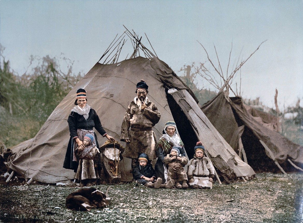 Colorized photo of a family of Sami, an indigenous nomadic people who once roamed much of Scandinavia since ancient times, and still exist in the north of Sweden and elsewhere (1900).