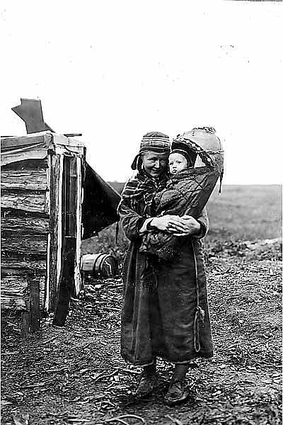 Sami reindeer herder Ellen Sara in Alaska holding her baby sister Berit — the Sami, a Scandinavian ethnic group originally from Sweden, Norway, Finland and the Kola Peninsula in Russia (c.1906).
