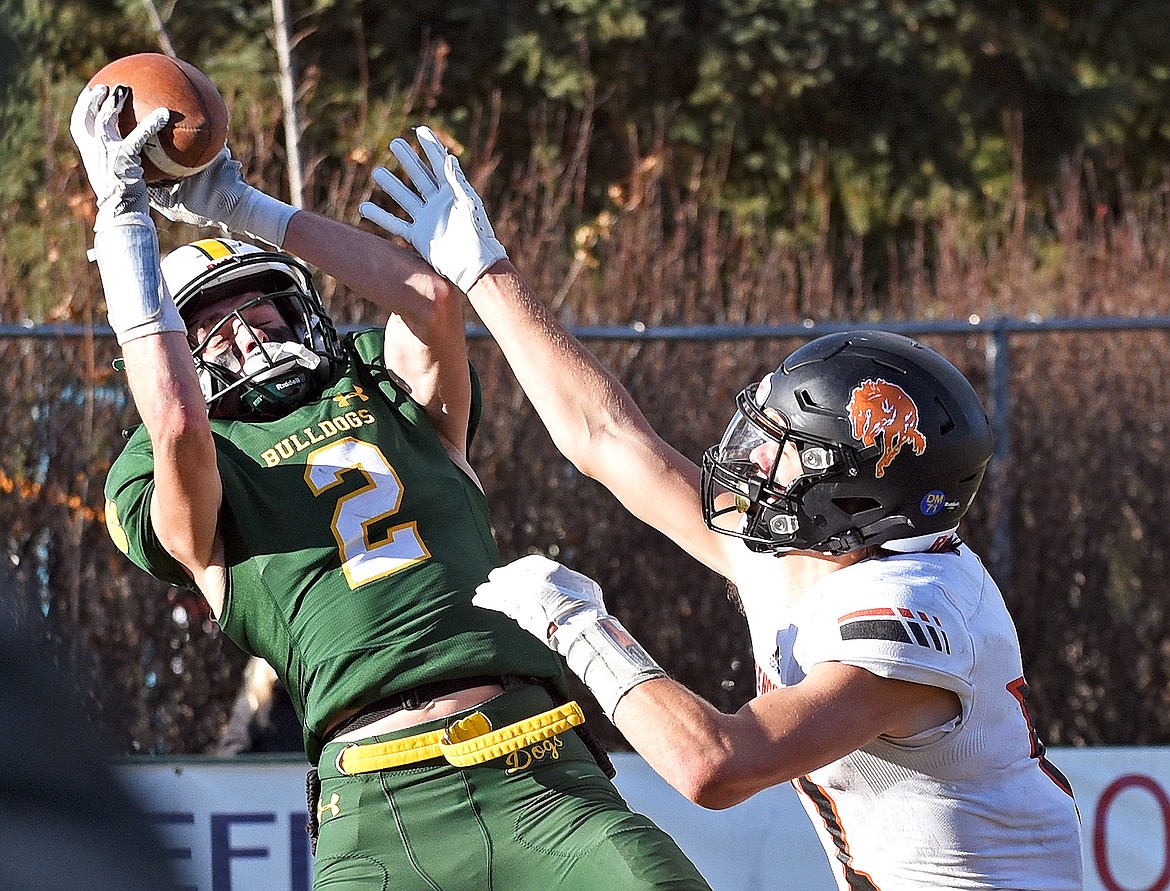 Bulldog Bodie Smith catches a long touchdown pass in a playoff game against Frenchtown this season. (Whitney England/Whitefish Pilot)