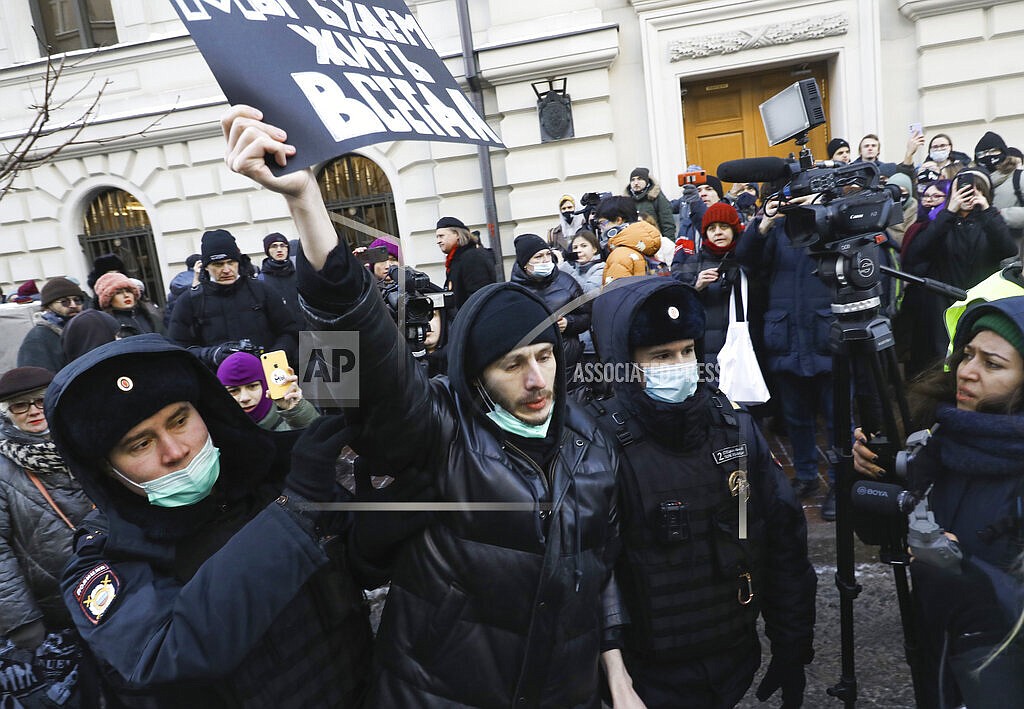 Police officers detain a demonstrator as people gather in front of the Supreme Court of the Russian Federation, in Moscow, Russia, Tuesday, Dec. 28, 2021. Russia’s Supreme Court has ruled that one of the country’s oldest and most prominent human rights organizations should be shut down. The move is the latest step in a months-long crackdown on dissent. The Prosecutor General’s Office last month petitioned the Supreme Court to revoke the legal status of Memorial — an international human rights group that rose to prominence for its studies of political repression in the Soviet Union. (AP Photo)