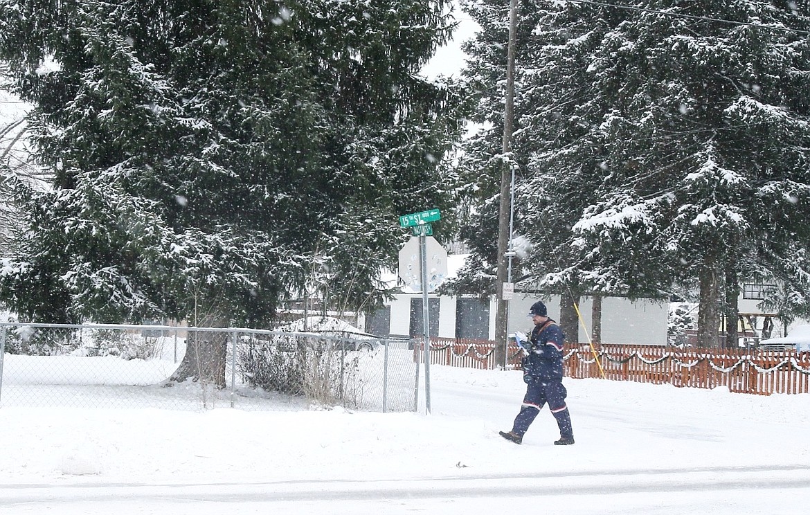 Mail carrier Bradley Robb, seen here Tuesday on his 15th Street route, is one of many local workers who will be braving single-digit temperatures as Arctic air chills North Idaho this week.