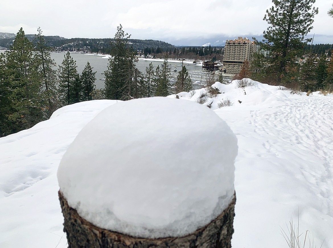 The Coeur d'Alene Resort rests in the background of a snowy Tubbs Hill on Sunday.