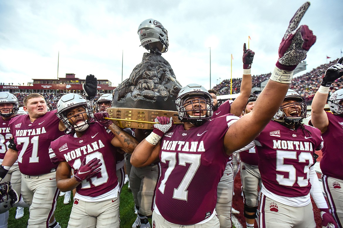 Montana celebrates with the Great Divide Trophy after a 29-10 win over Montana State at Washington-Grizzly Stadium on Saturday, Nov. 20. (Casey Kreider/Daily Inter Lake)