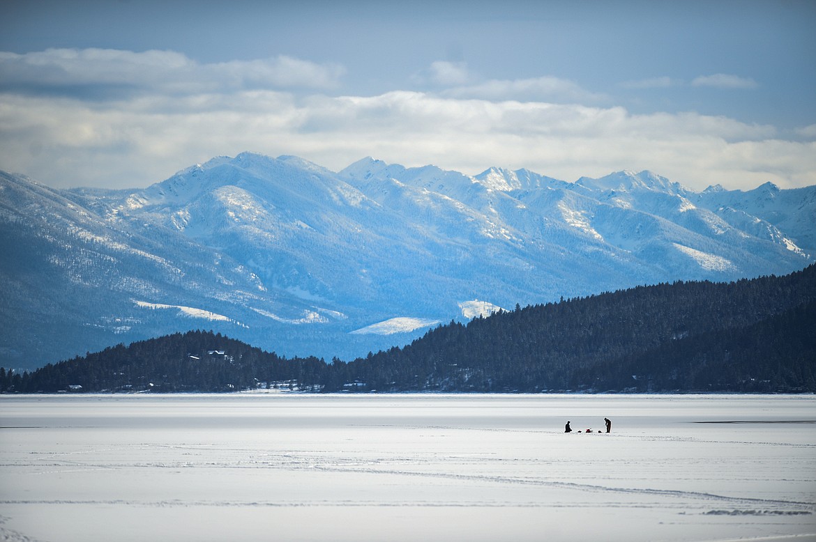 Two ice fishers wait for bites on Somers Bay at Flathead Lake on Thursday, Feb. 18. (Casey Kreider/Daily Inter Lake)