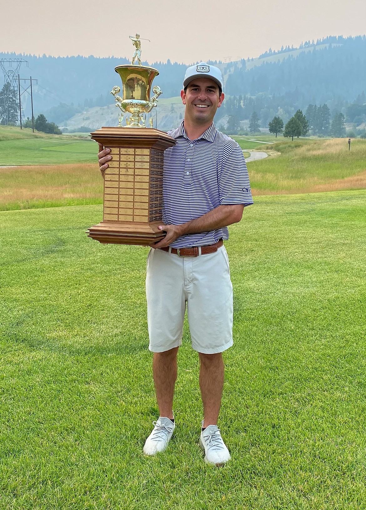 Joey Lovell, a 2006 Sandpoint High grad, holds up the men’s Montana State Amateur Championship trophy.