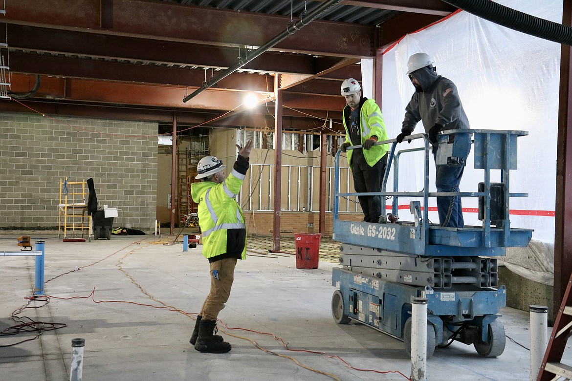 From left, construction workers Ken Sheets, Blake Cooper and Hunter Fliger work on the Meyer Health and Science building expansion on Dec. 29 at North Idaho College. HANNAH NEFF/Press