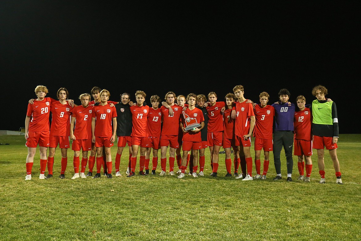 The Sandpoint boys soccer team poses for a photo with the second-place state trophy.