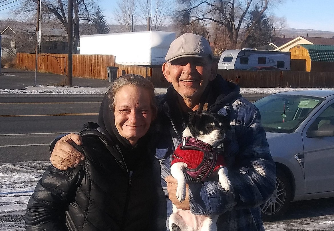 Shawna Kluge, left, poses for a photo with Richard Balck. Black, holding his rescue dog Teddy, is a recent transplant to Moses Lake and donated $1,500 to Kluge for Brandi Del Monte’s end-of-life expenses and the spaying of the dog she leaves behind.