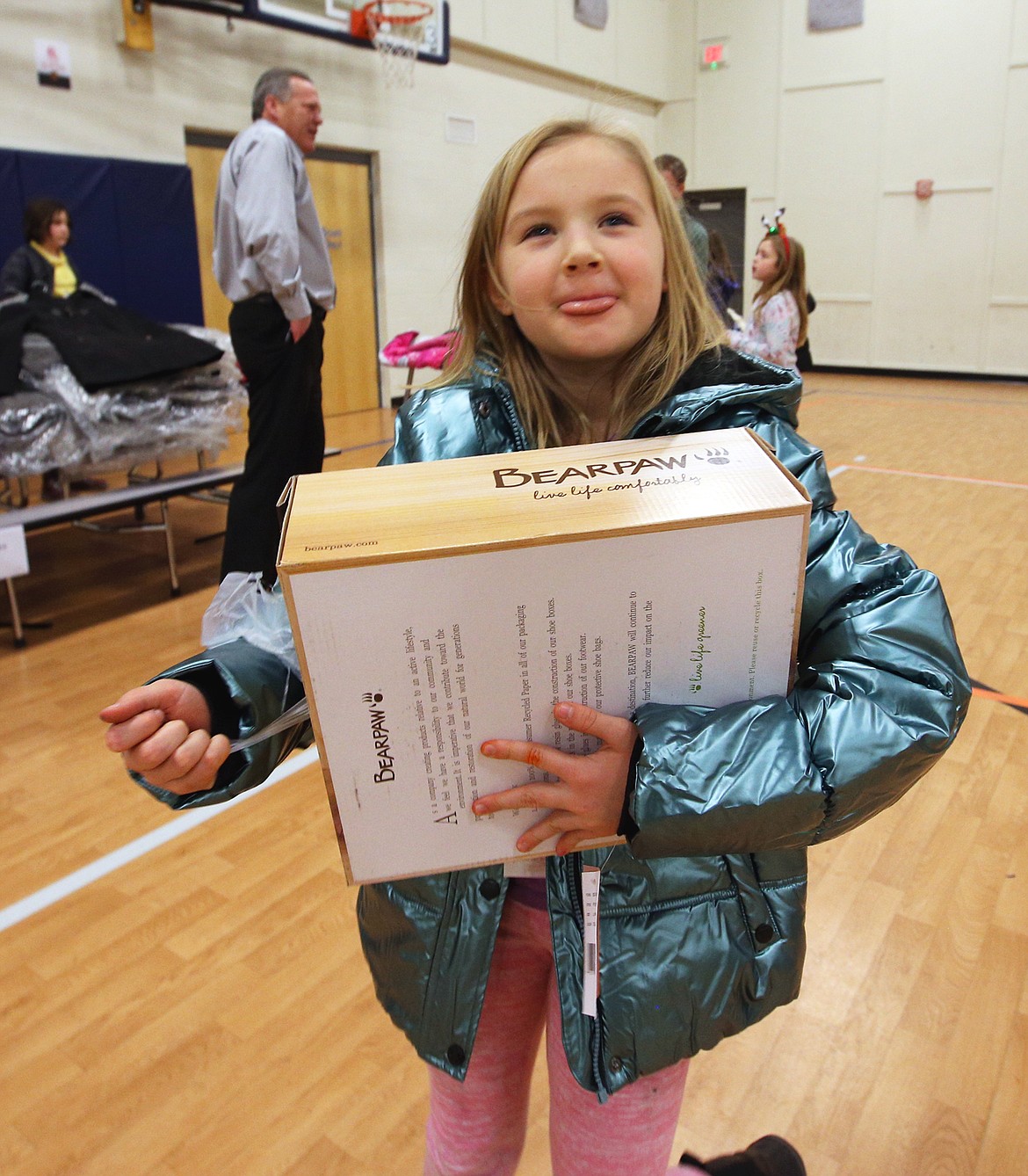 Willow Calder smiles as she carries the new boots she received Dec. 14 at the Lola & Duane Hagadone Boys & Girls Club.