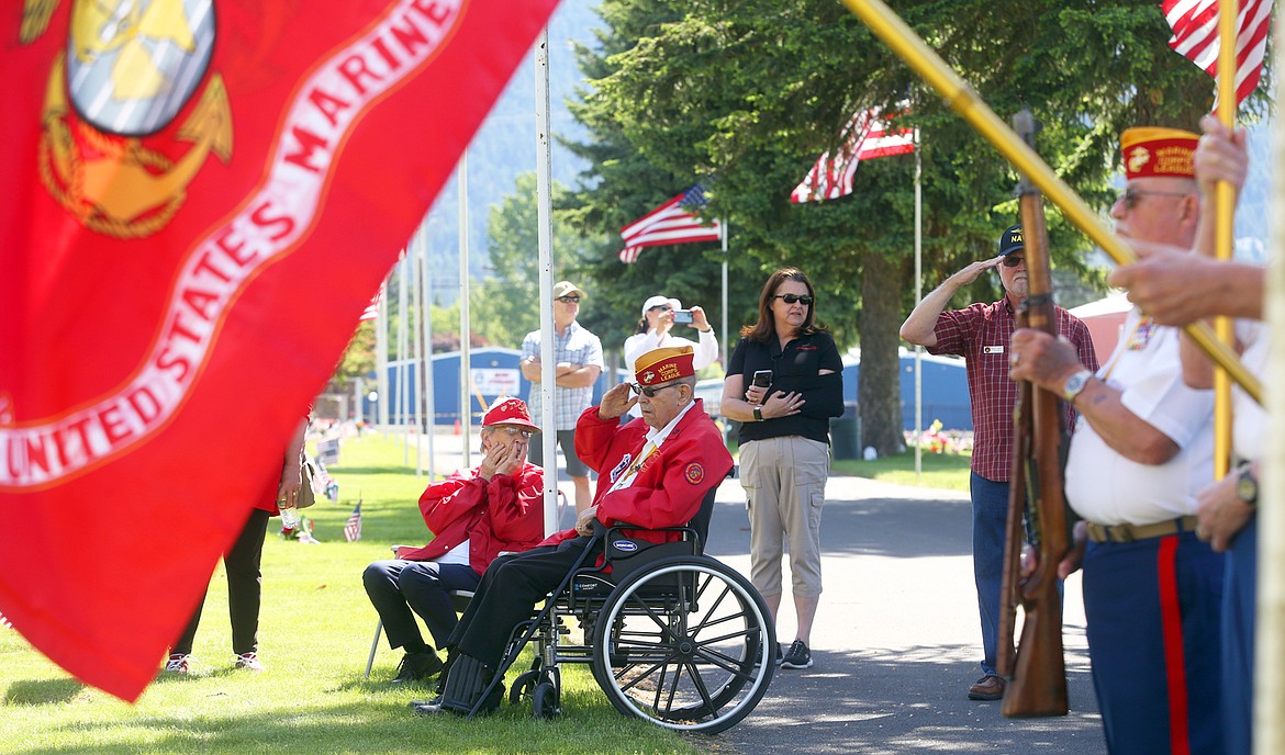 Paul Sullivan sits in his wheelchair, his wife Gladys next to him, as he salutes on Memorial Day at Coeur d'Alene Memorial Gardens.