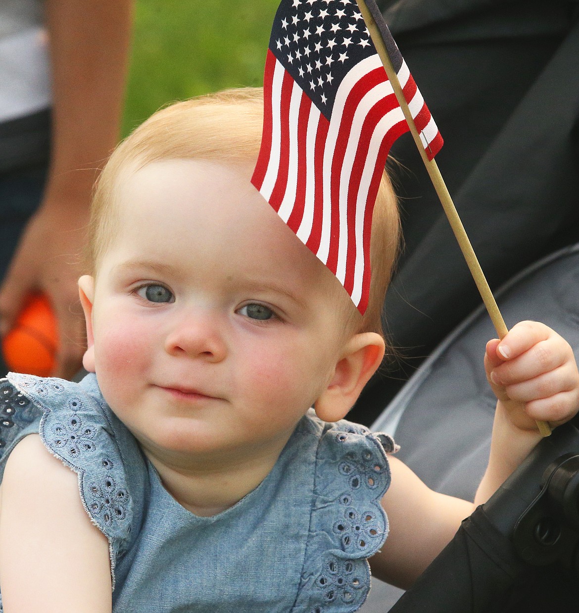 Claire Magnus holds a flag at Athol Daze on Aug. 14.