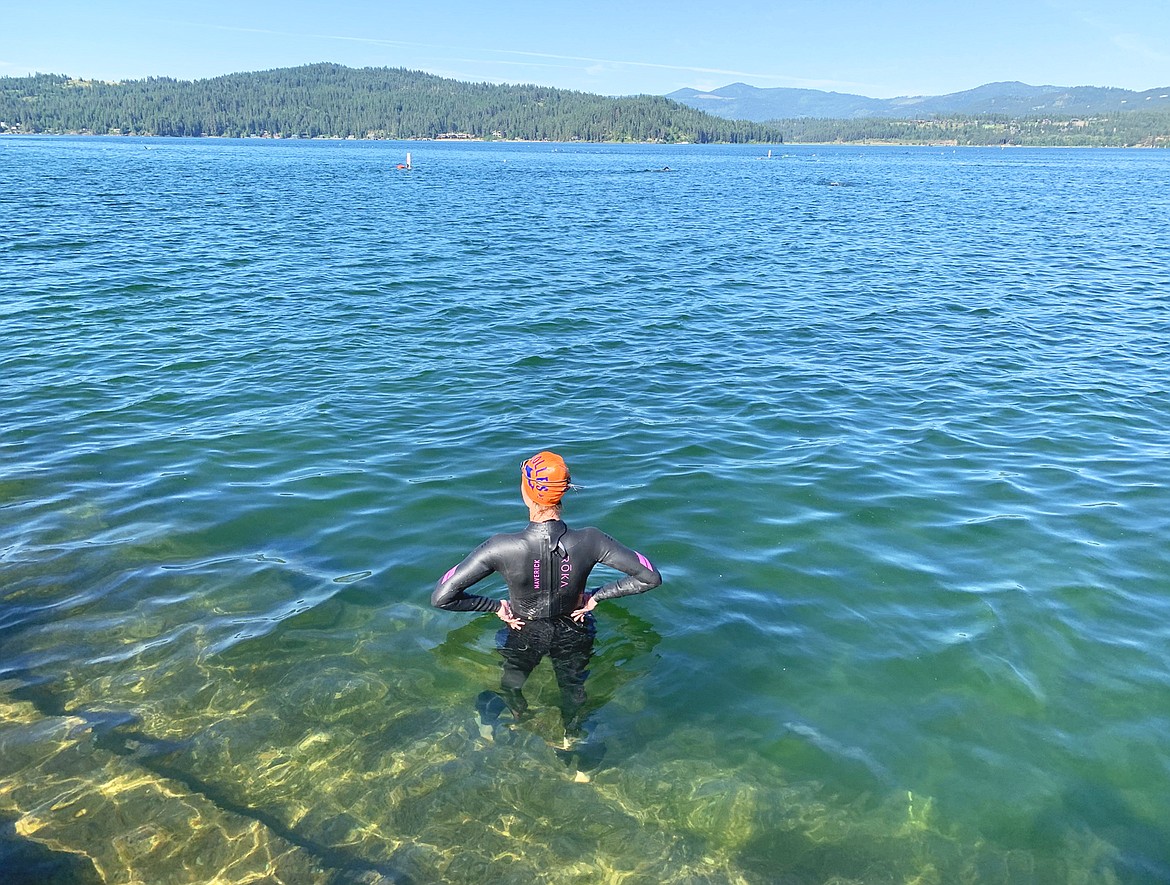 A swimmer stands at Independence Point looks out on Lake Coeur d'Alene after completing practice swim June 25 in preparation for Ironman Coeur d'Alene.