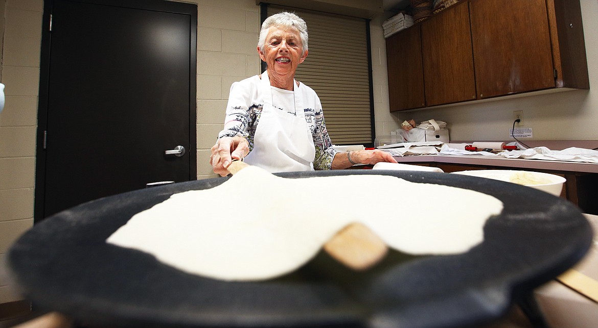 Beverly Knutson prepares to flip lefse on the grill at Trinity Lutheran Church on Sept. 30