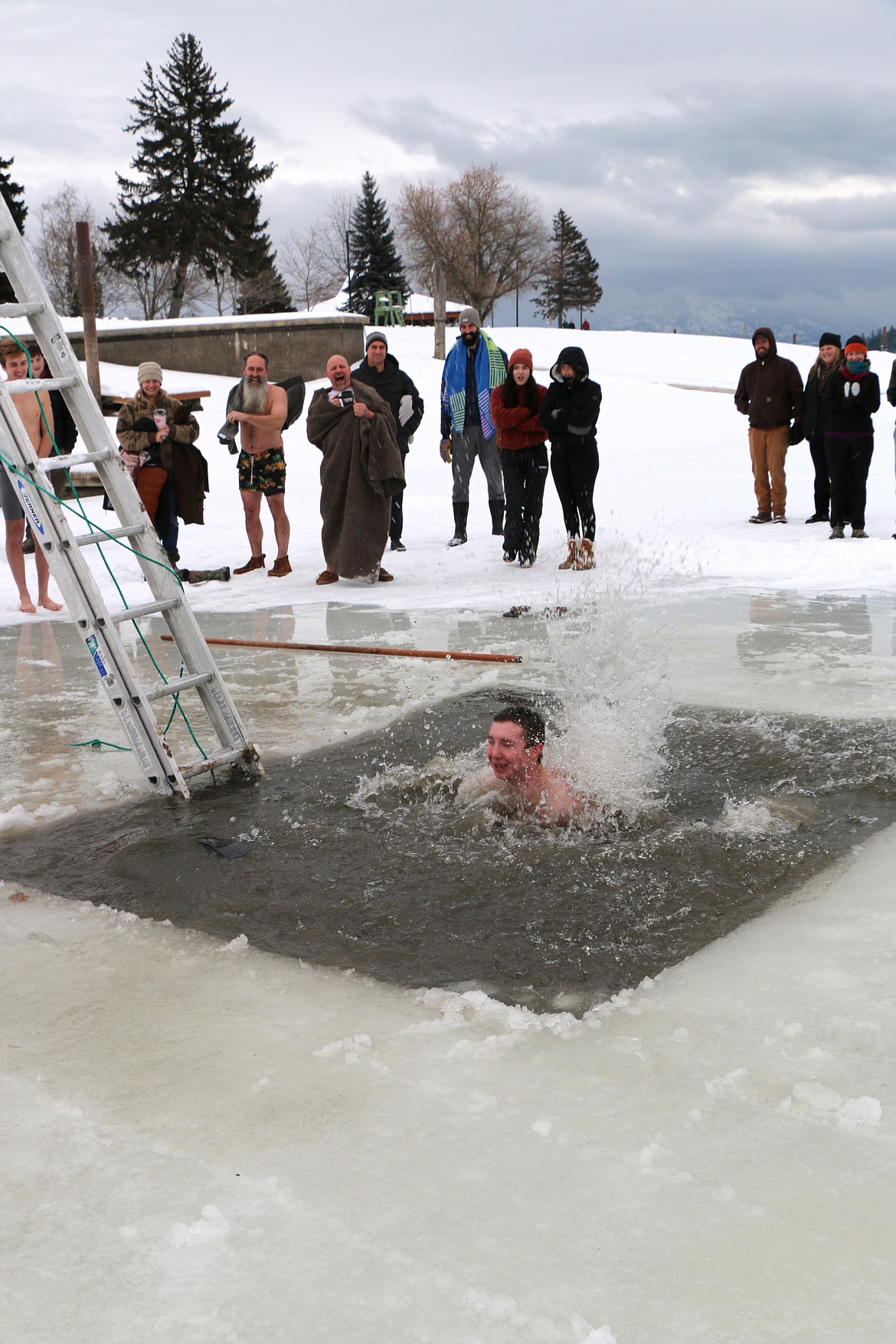 Jacob Slocome, home of Christmas leave from the U.S. Navy, jumps into Lake Pend Oreille during Boy Scout Troop 111's annual Polar Bear Plunge. Slocome was a member of the troop before entering the Navy.