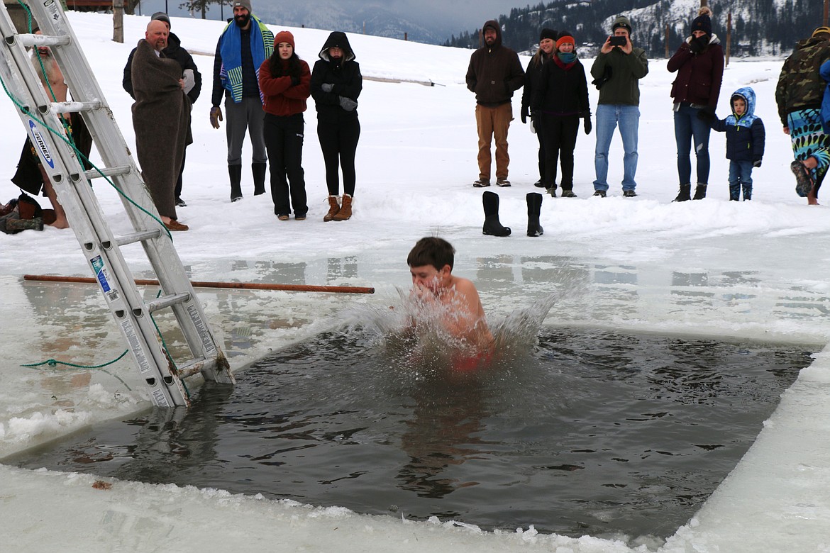 Kai Prather holds his nose and he takes part in the 2022 Polar Bear Plunge, an annual event held by Boy Scout Troop 111.