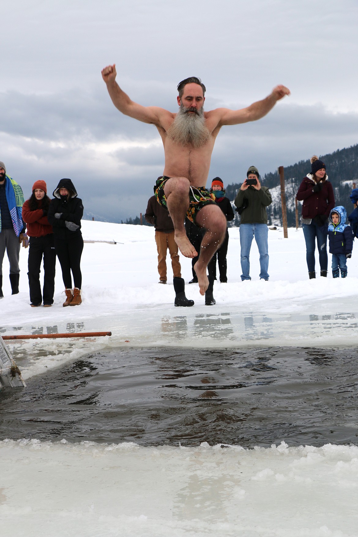 Tod Prather, the father of Boy Scout Kai Prather, a member of Troop 111, jumps into Lake Pend Oreille during Saturday's Polar Bear Plunge.