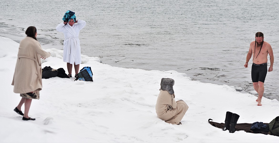 A small group that chose to take an early swim included Mandy Stebbins, wrapped in a white robe and blue towel, and a shirtless Michael Umphrey. (Scot Heisel/Lake County Leader)