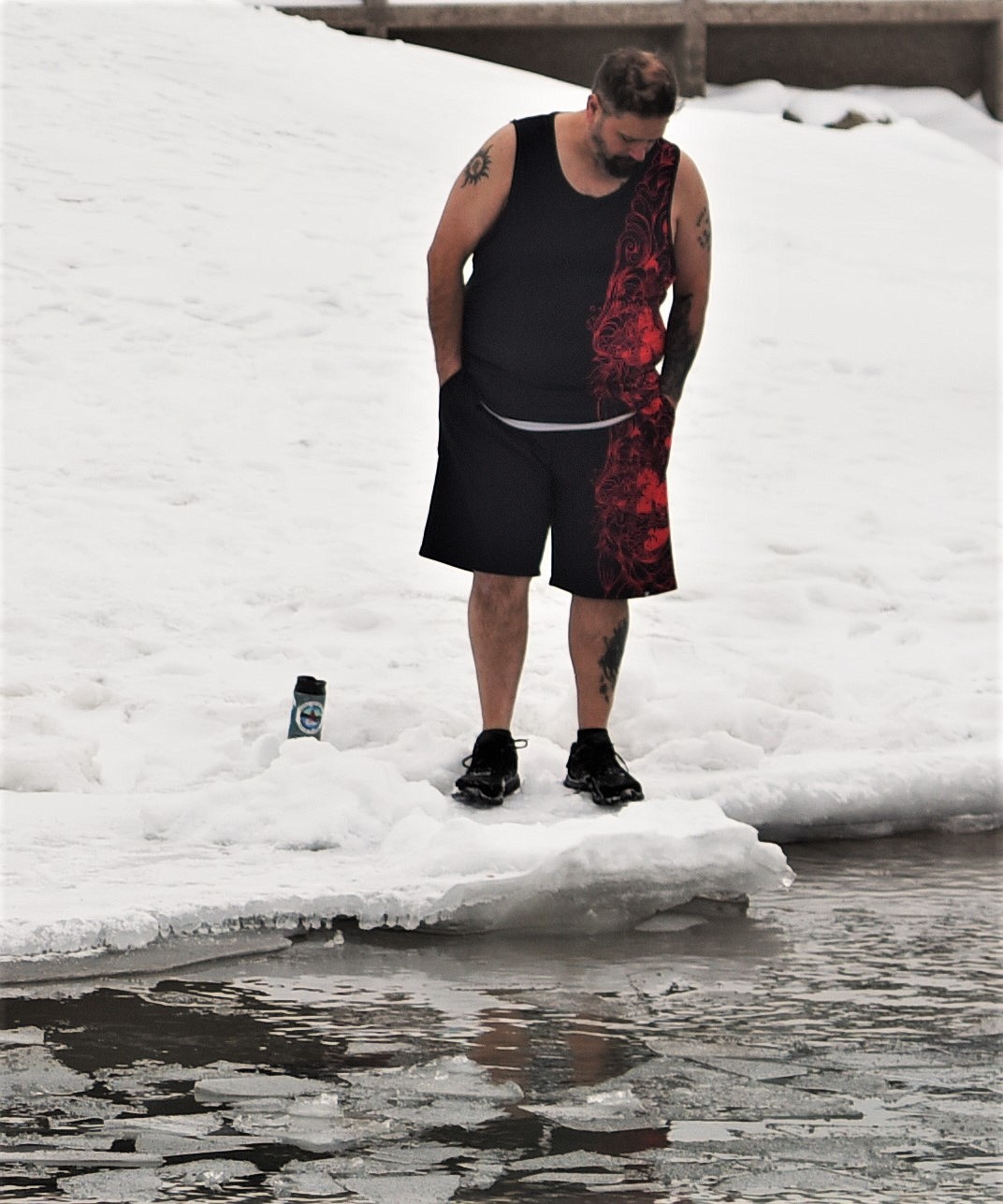 A polar plunge participant checks out the water, which is covered by floating chunks of ice. (Scot Heisel/Lake County Leader)