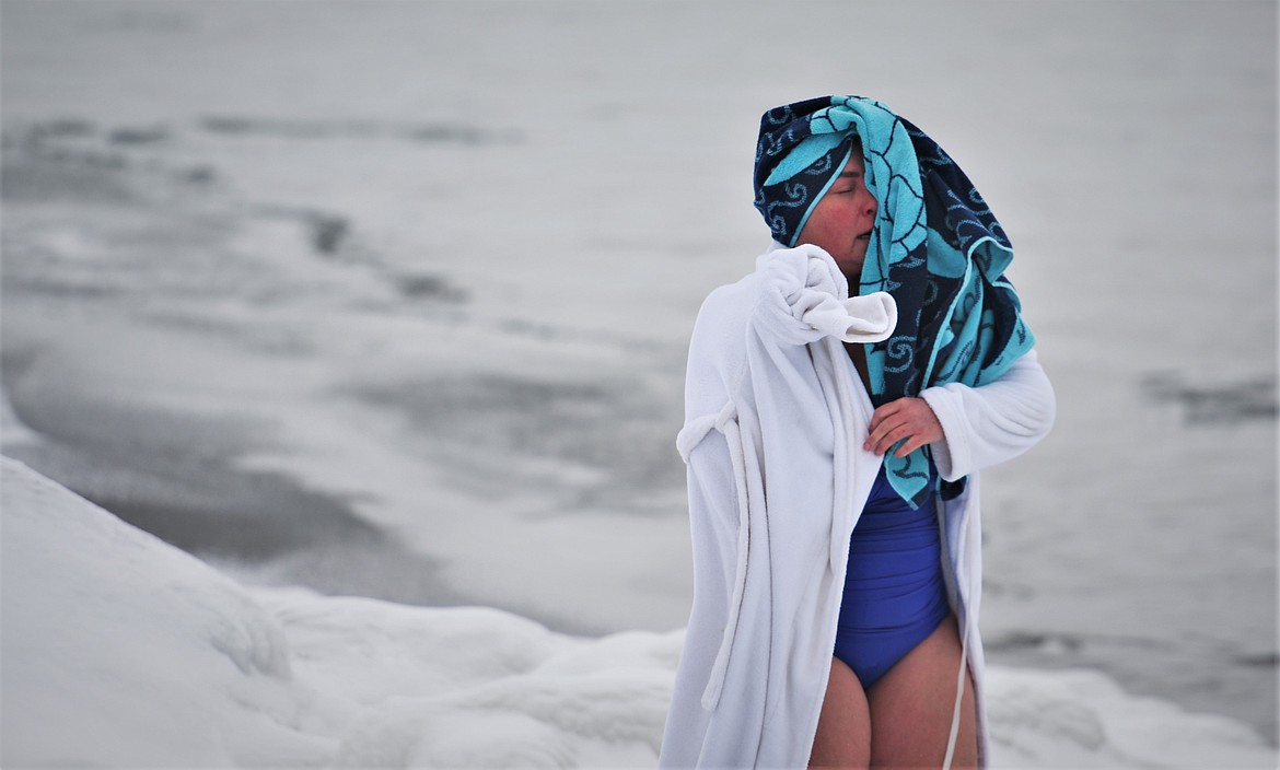 Mandy Stebbins dries off and wraps up after her swim. (Scot Heisel/Lake County Leader)