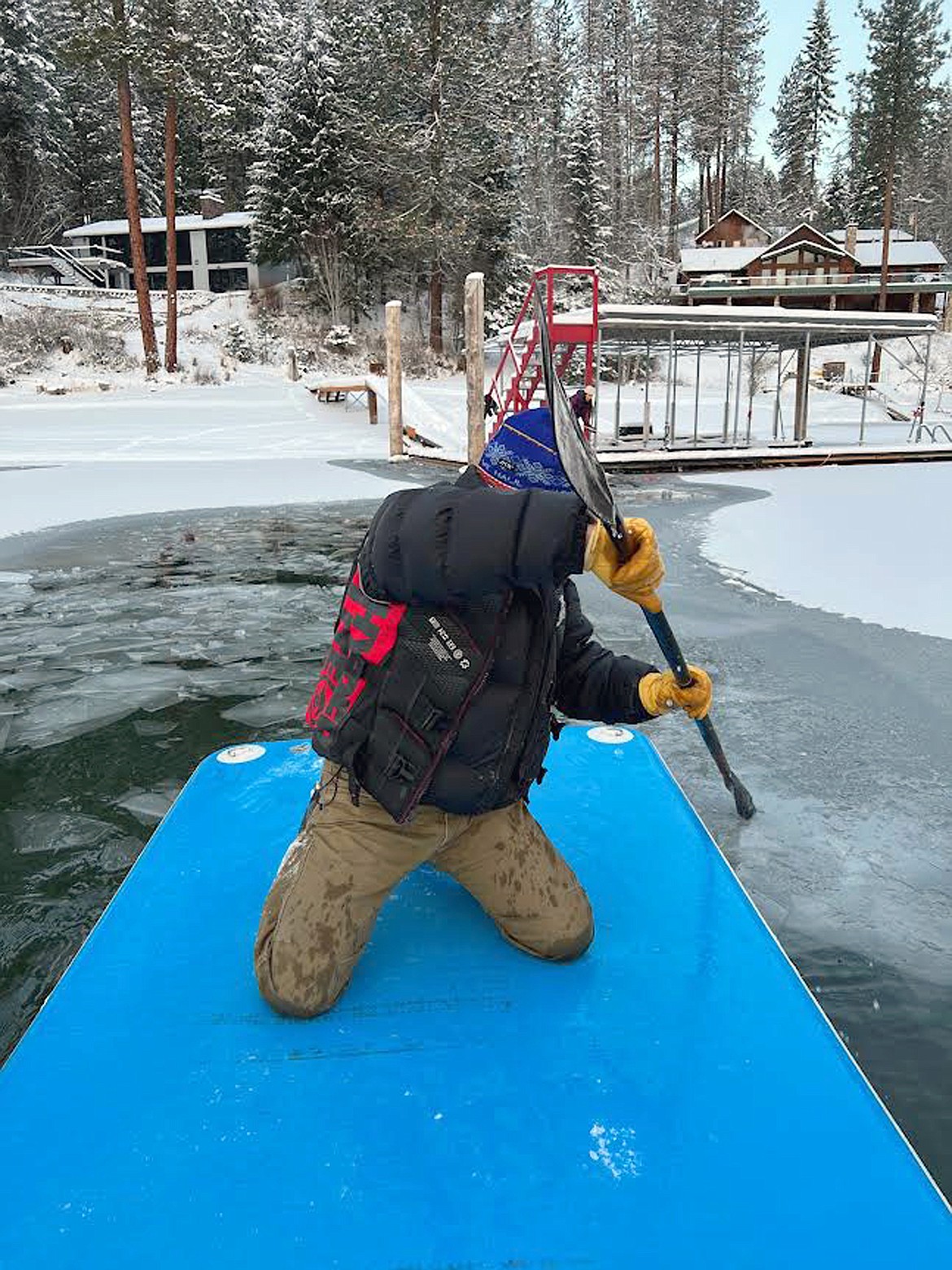 Mark Bauer paddles out to rescue a deer at Hayden Lake Friday morning.