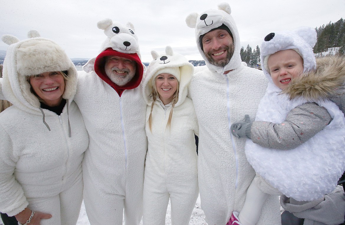 Brenda and Mario Spangenberg of Coeur d’Alene, left, along with Frederick and Jen De Loizaga and their daughter Genevieve, wear polar bear outfits for the Polar Bear Plunge on Saturday.