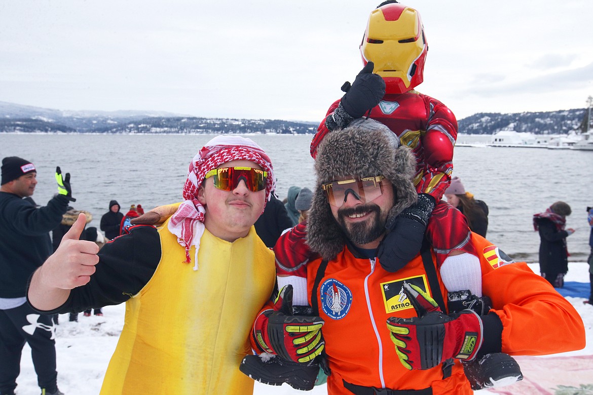Joe Guzman wears an astronaut outfit, son Cruz sports an Ironman suit and nephew Landon Vigil is dressed as a banana for the Polar Bear Plunge on Saturday.