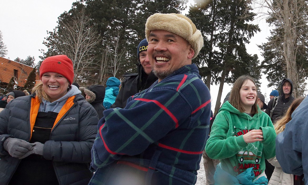 Rho Zaragoza of Coeur d’Alene smiles while warming up after Saturday's Polar Bear Plunge at Sanders Beach.