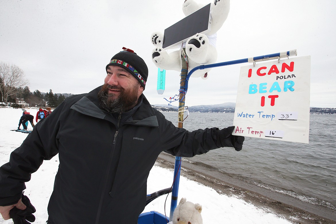 Jake Radtke poses by the Polar Bear Plunge sign and countdown timer before going into Lake Coeur d'Alene on Saturday.