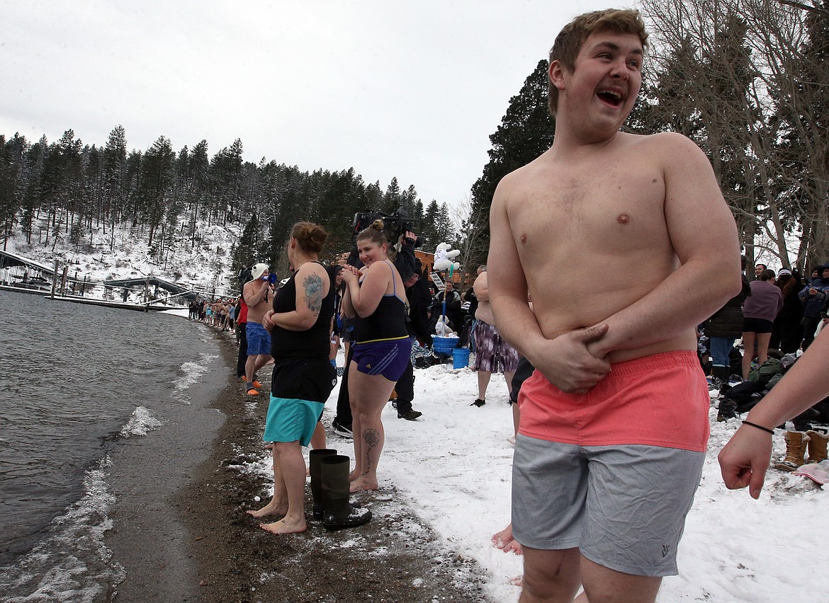 People begin lining up on the shores of Sanders Beach for the Polar Bear Plunge on Saturday.