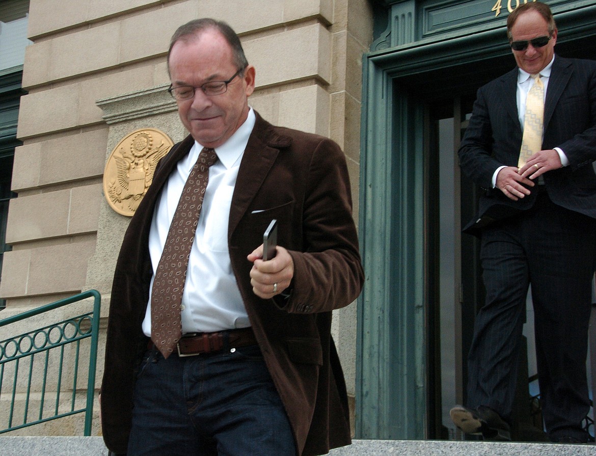 In this Nov. 3, 2014, file photo, Tim Blixseth, left, leaves a federal courthouse in Butte after facing questions about his finances. Blixseth has filed a complaint against the state of Montana seeking $800 million in damages and $10 million in attorneys fees after a U.S. Bankruptcy Court judge ruled in June 2019 that the state of Montana did not have legal standing to file a petition to force him into bankruptcy in 2011 to collect back taxes the state said he owed. (AP Photo/Matthew Brown, File)