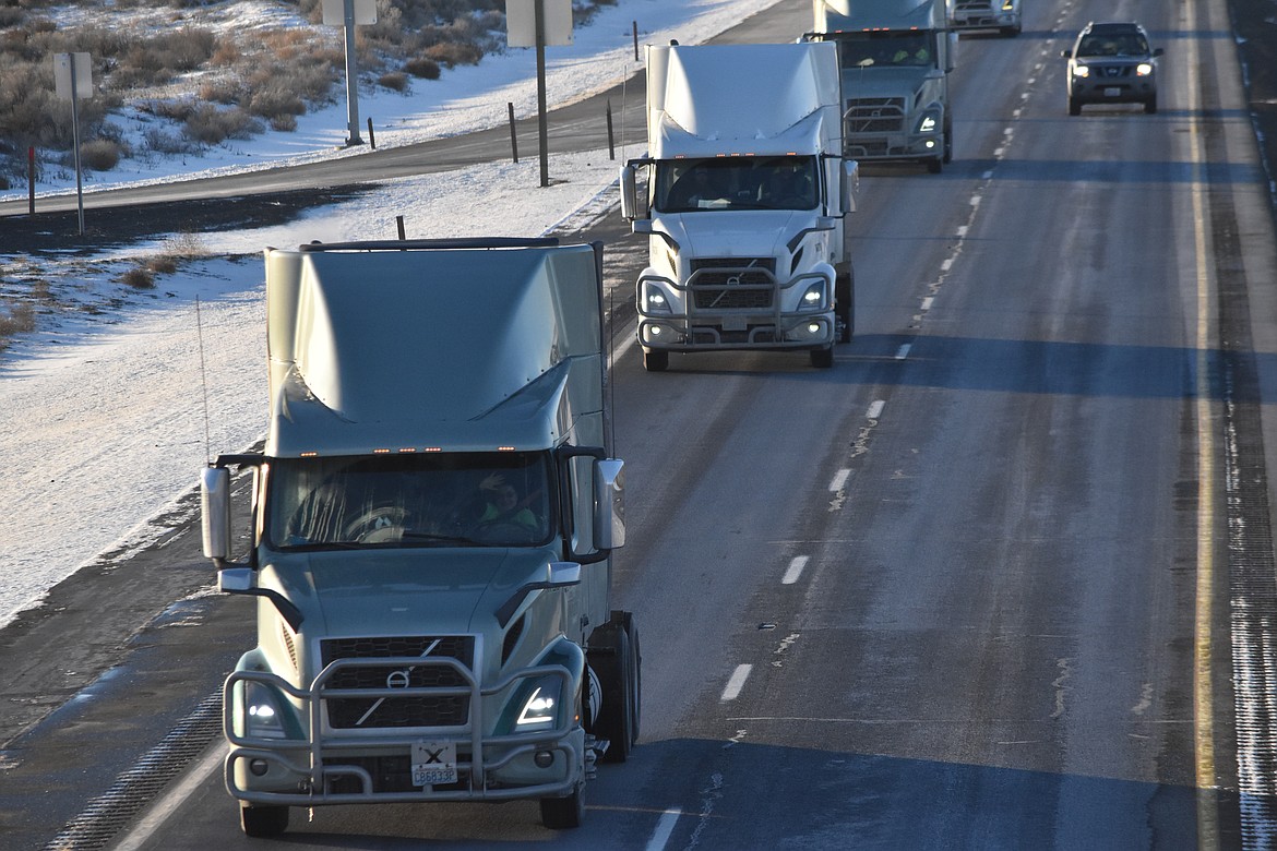 A convoy of semis, seen from the Hiawatha Road overpass, drive along Interstate 90 Friday to send off Max Neff.