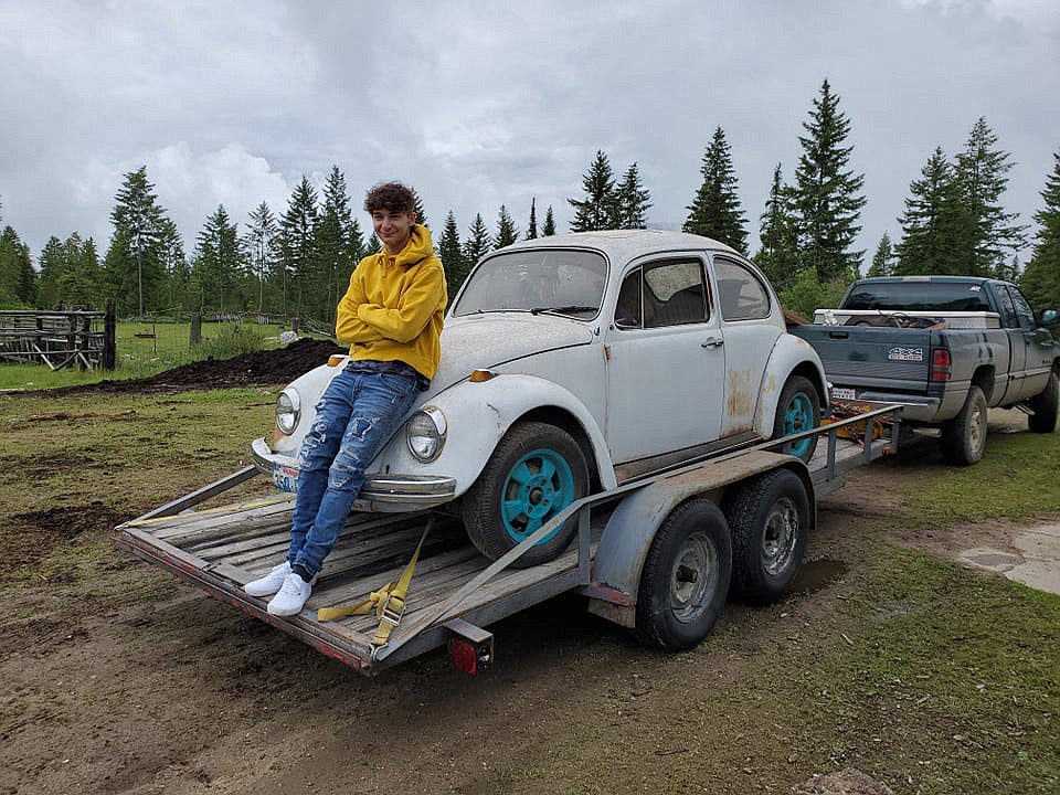 Max Neff with the Volkswagen Beetle he and his father were in the process of restoring.