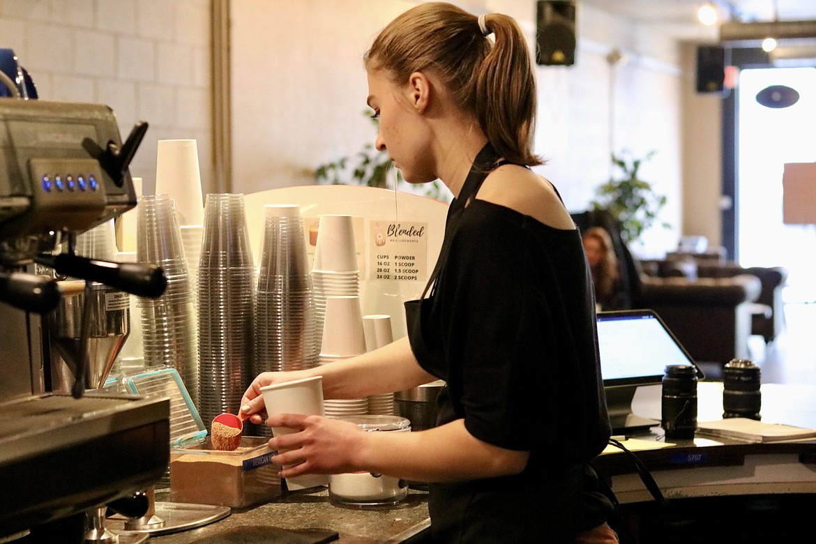 Barista Grace Dougall of Coeur d'Alene makes a hot beverage at Lyfe Coffee Roasters and Public House in downtown Coeur d'Alene, previously called Calypsos Coffee Roasters. The coffee shop opened with their new name under new ownership on Sunday. HANNAH NEFF/Press