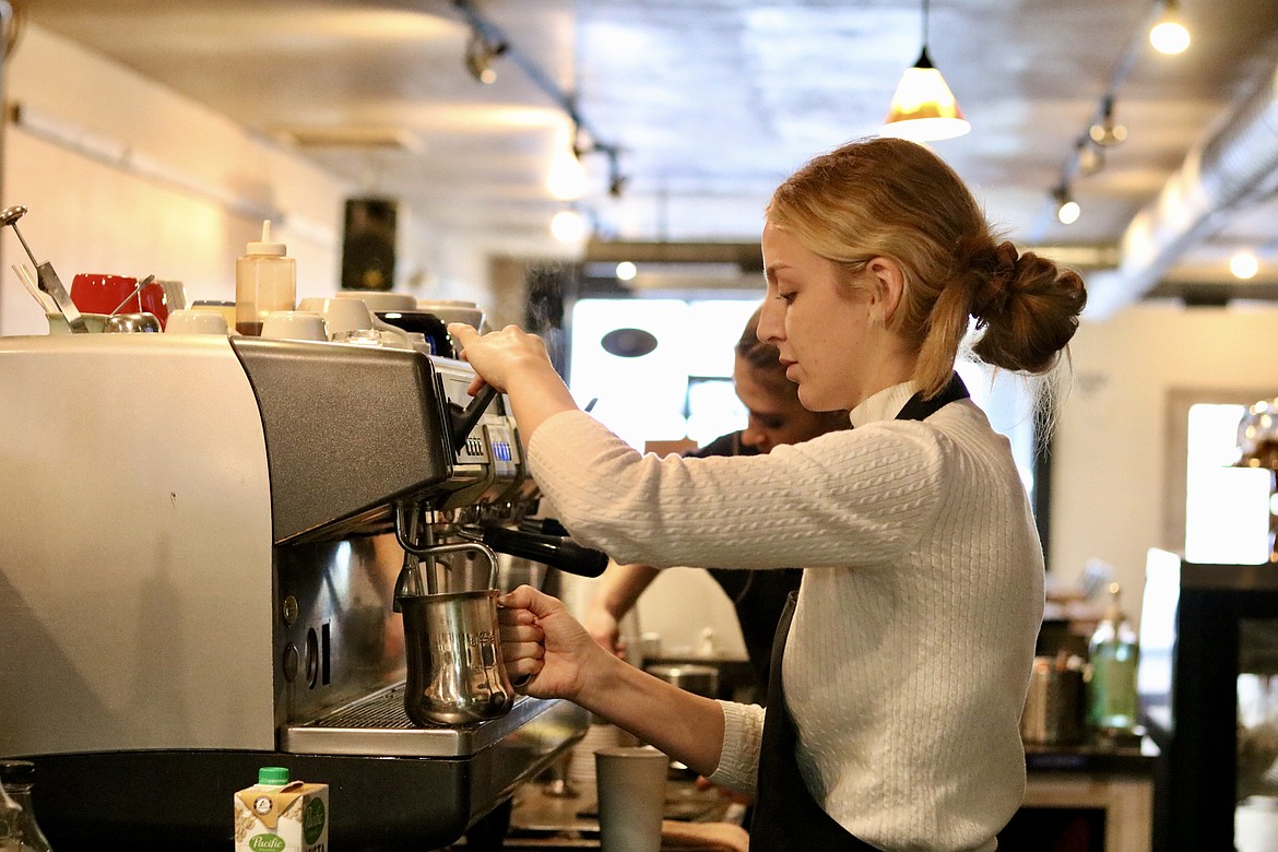 Baylie Miller of Coeur d'Alene makes a drink at Lyfe Coffee Roasters and Public House in downtown Coeur d'Alene, previously called Calypsos Coffee Roasters. The business opened Sunday with their new name under new ownership. HANNAH NEFF/Press