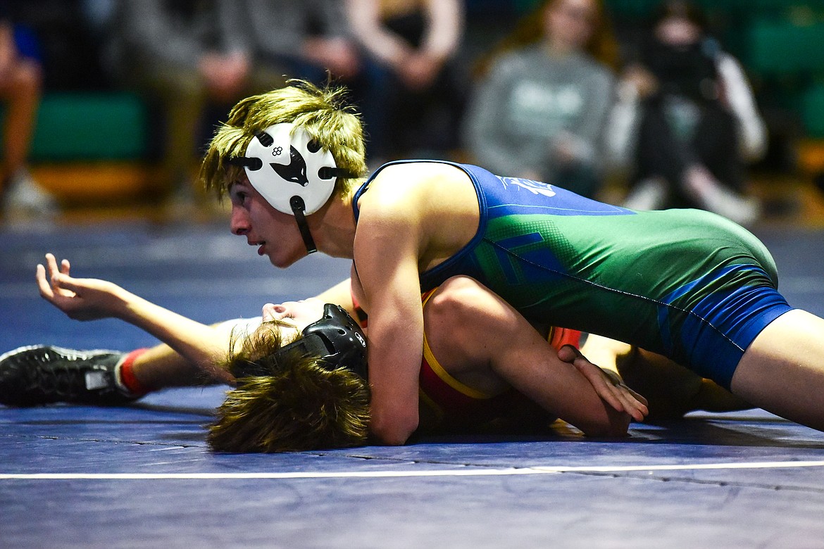 Glacier's CJ Johnson works toward a pin of Missoula Hellgate's Grady Caton at 120 pounds at Glacier High School on Tuesday, Jan. 4. (Casey Kreider/Daily Inter Lake)