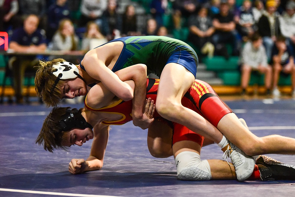 Glacier's CJ Johnson works toward a pin of Missoula Hellgate's Grady Caton at 120 pounds at Glacier High School on Tuesday, Jan. 4. (Casey Kreider/Daily Inter Lake)