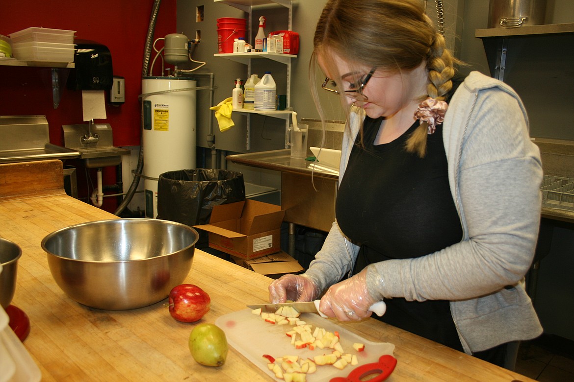 Jocelyn Hunter chops apples at the Red Door Cafe, which got new owners in 2021.