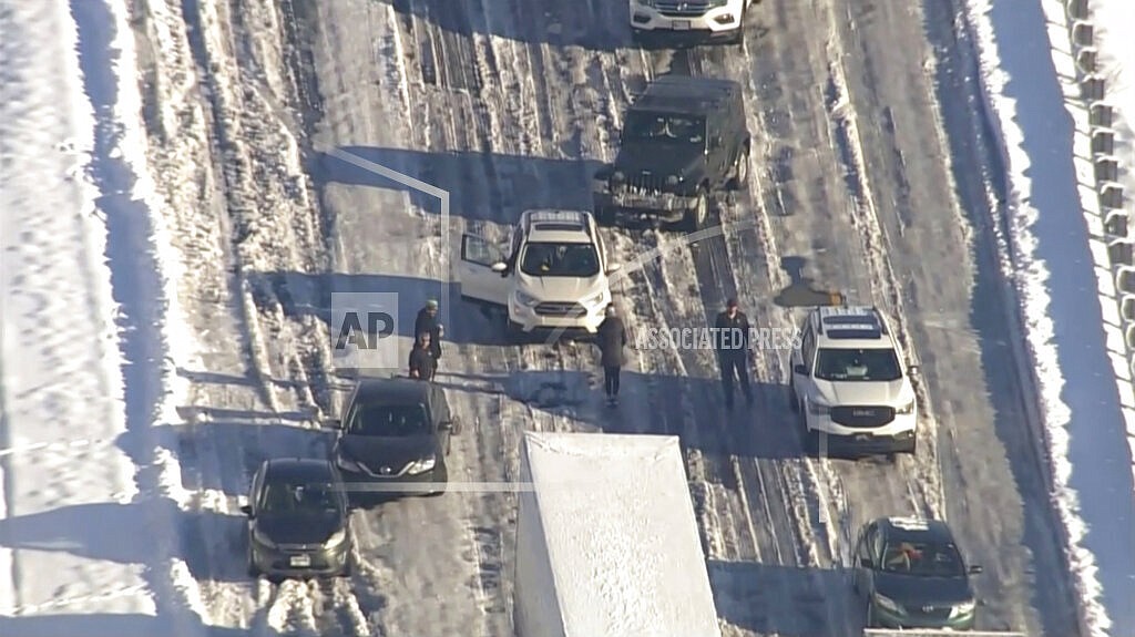 Motorists sit stranded on Interstate 95 near Fredericksburg, Va, on Tuesday, Jan. 4, 2022. Hundreds of motorists were stranded all night in snow and freezing temperatures along a 50-mile stretch of Interstate 95 after a crash involving six tractor-trailers in Virginia, where authorities were struggling Tuesday to reach them. (WJLA via AP)