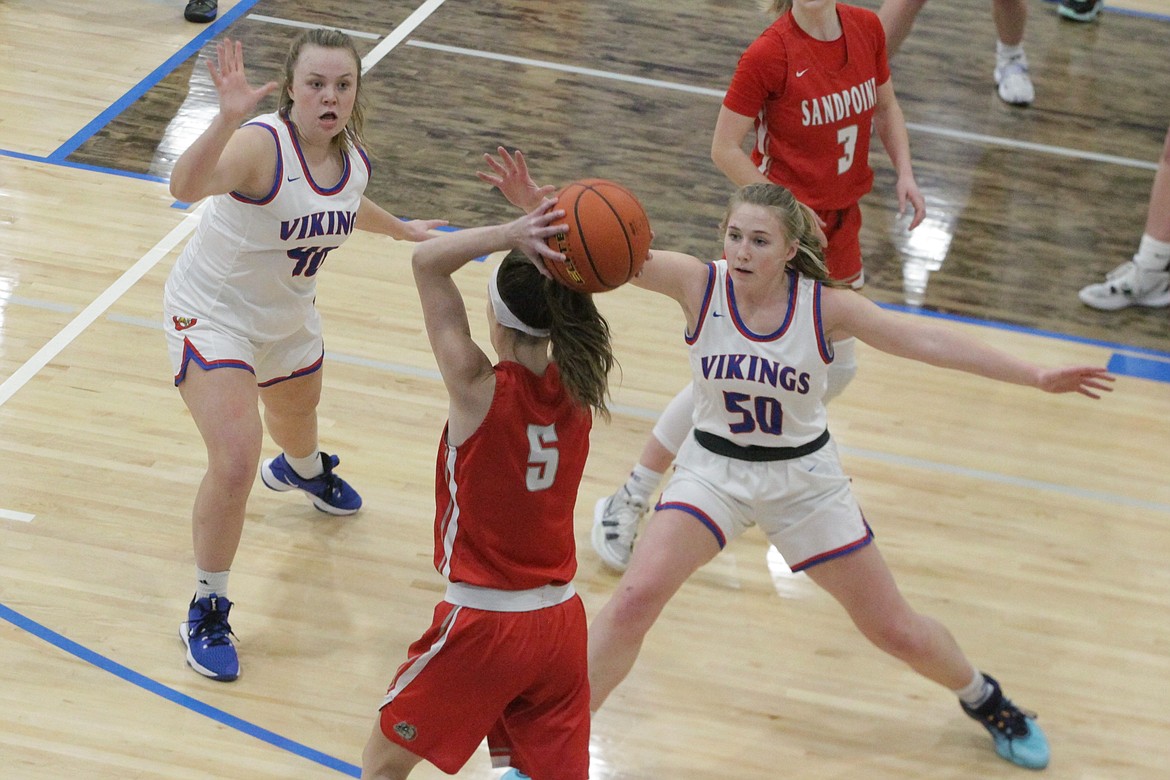 JASON ELLIOTT/Press
Coeur d'Alene sophomore guard Kendall Holecek (40) and senior forward Lily Phenicie (50) trap Sandpoint wing Anna Reinink during Tuesday's game at Viking Court.