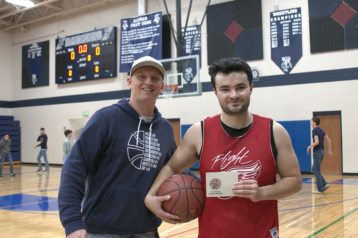 BFHS Athletic Director Nathan Williams awards (right) Max from Team Bombers with a gift card to Pizza Factory after Max won the three-point contest. He was 13 for 20.