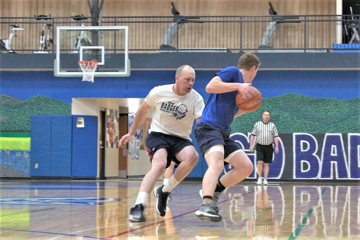 Team Rice player plays tough defense against Team Blackmore player.