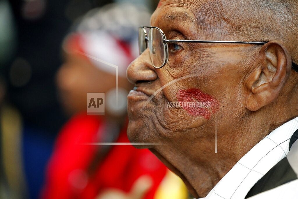 World War II veteran Lawrence Brooks sports a lipstick kiss on his cheek, planted by a member of the singing group Victory Belles, as he celebrates his 110th birthday at the National World War II Museum in New Orleans, Thursday, Sept. 12, 2019. The oldest World War II veteran in the United States has died at the age of 112. Lawrence N. Brooks died Wednesday, Jan. 5, 2022 in New Orleans. His death was announced by the National World War II Museum and confirmed by his daughter. (AP Photo/Gerald Herbert, File)