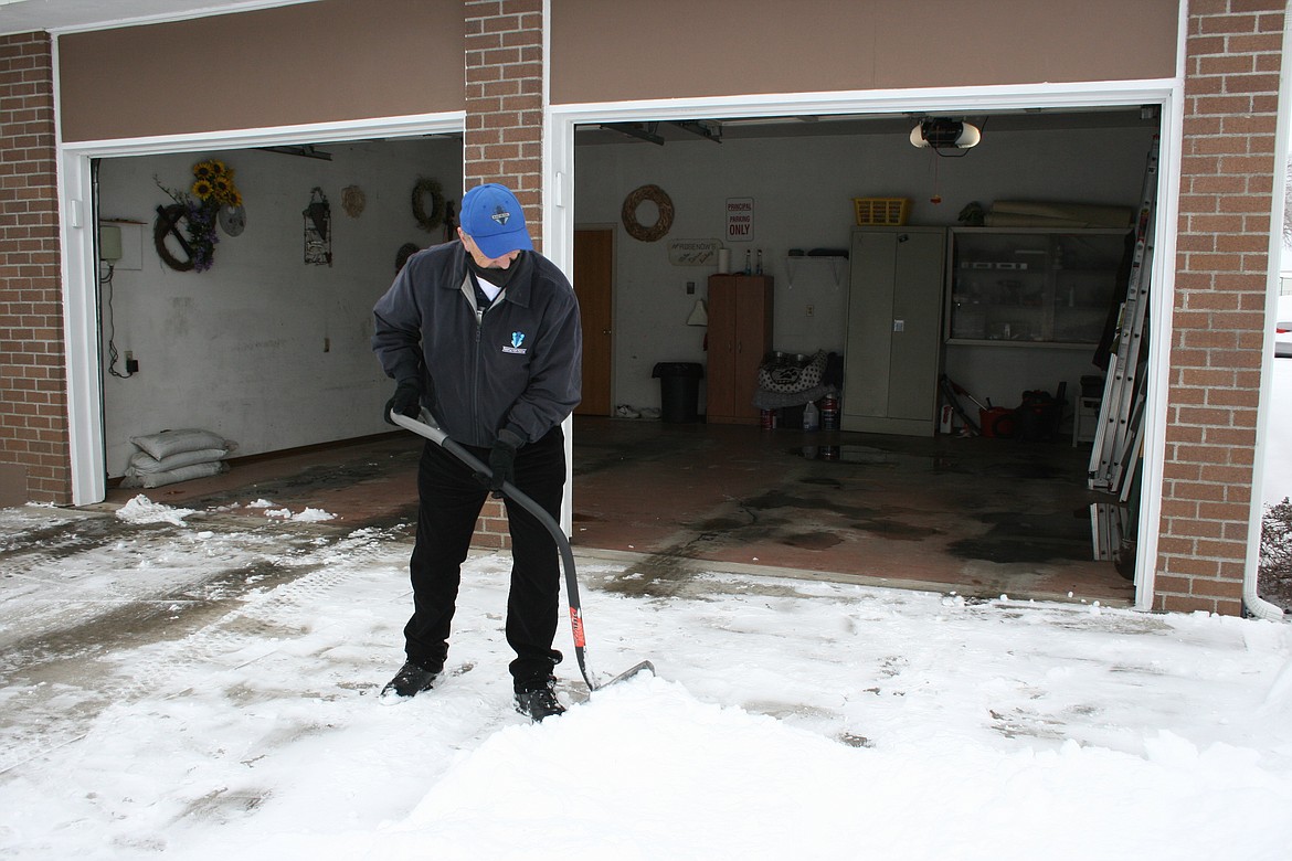 Mike Rosenow shovels snow to the edge of a Moses Lake driveway Thursday, just as city officials ask.