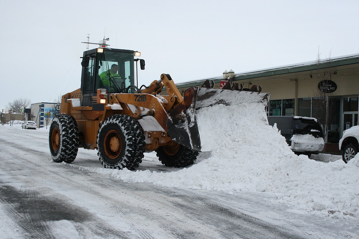 Snow is piled up for removal Thursday morning on Third Avenue in Moses Lake.