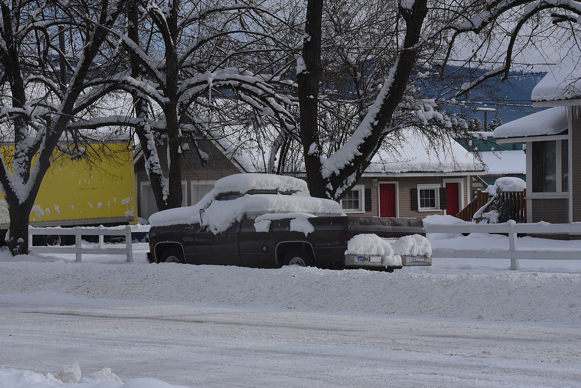 A snow covered pickup sits adjacent to the road following a string of winter storms in Libby. (Derrick Perkins/The Western News)